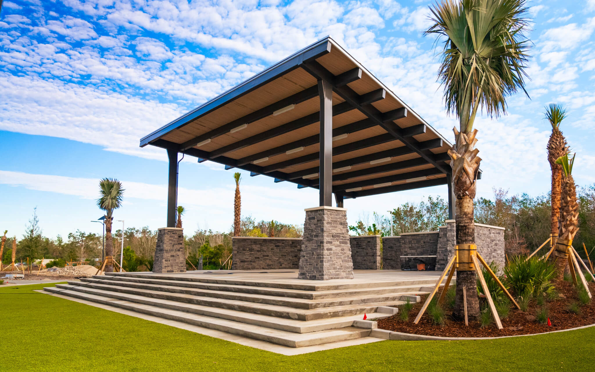 terraced amphitheater surrounded by palm trees on a sunny day at Parrish Community Park - one of many outdoor activities in Parrish FL
