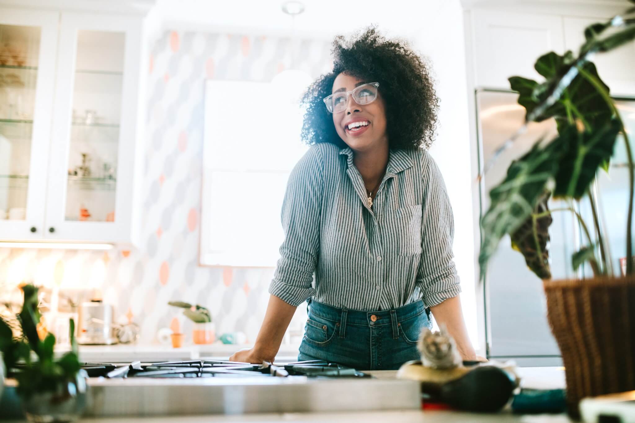 A Young Woman Relaxes in Her Modern Home Kitchen