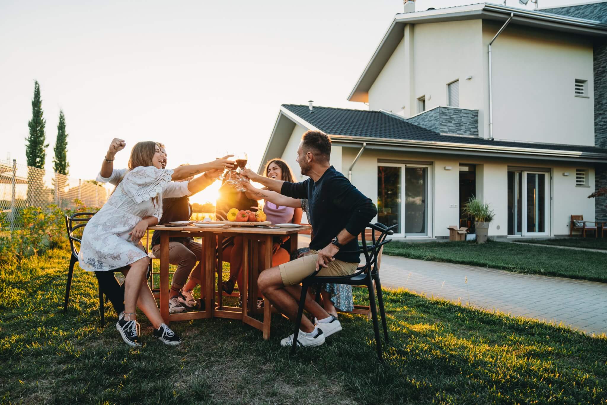 GettyImages-1472375191-scaled Friends relaxing in the backyard